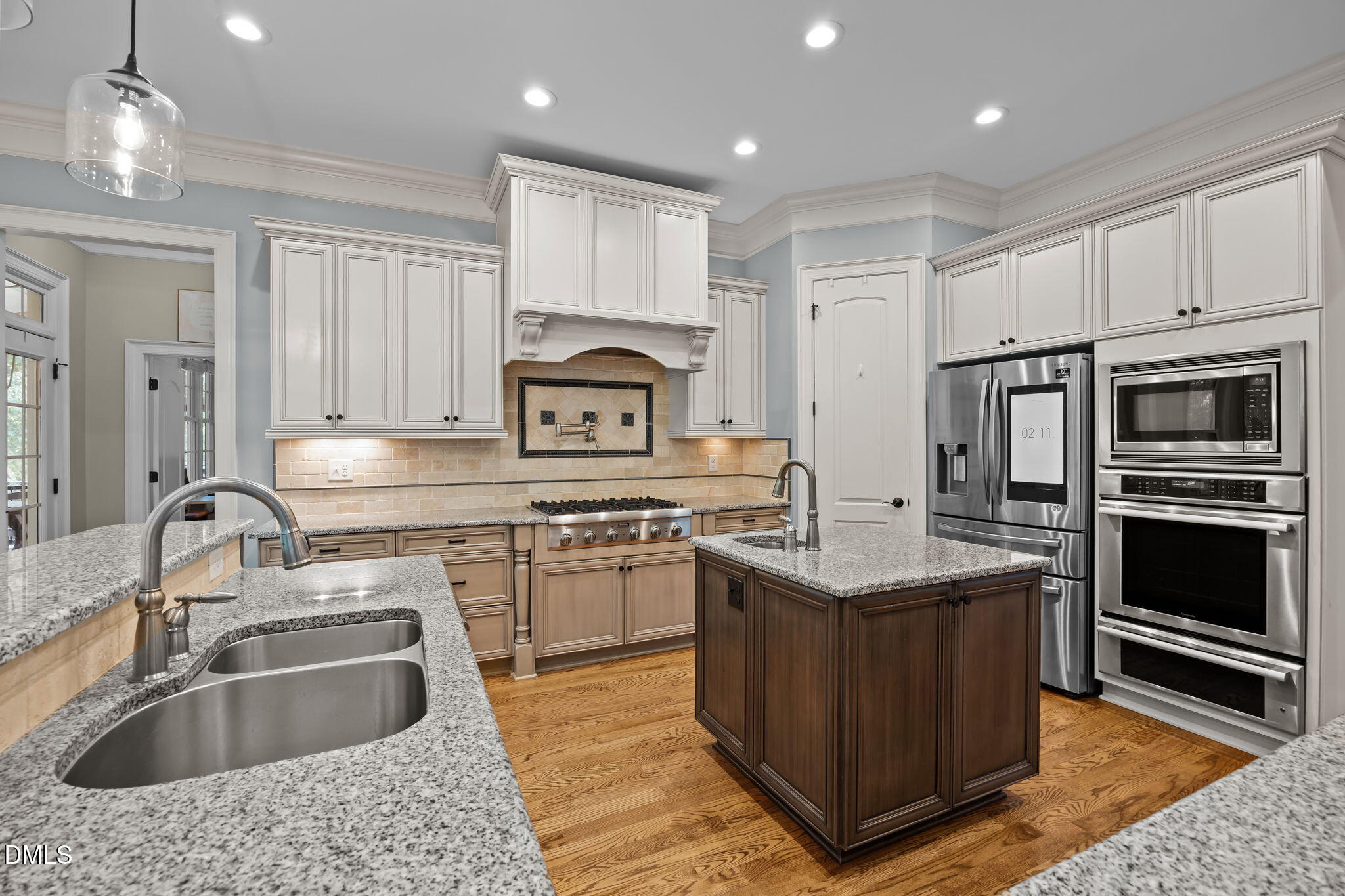 8802 Fidelis Lane Raleigh, NC 27613 - Photo 18 of 60 a kitchen with stainless steel appliances granite countertop a sink stove and refrigerator