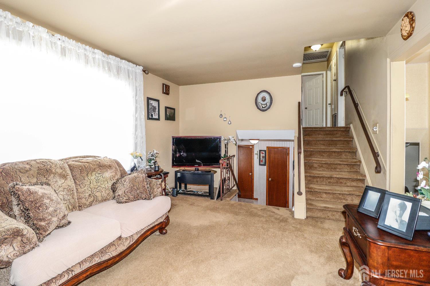 37 Patrick Street Carteret, NJ 07008 - Photo 12 of 30 a living room with furniture and a flat screen tv