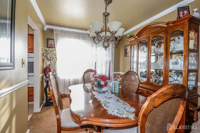 a view of a dining room with furniture and chandelier