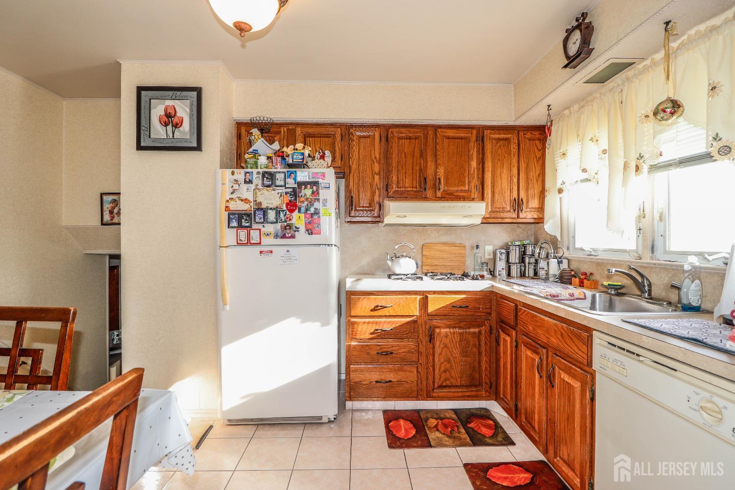 37 Patrick Street Carteret, NJ 07008 - Photo 17 of 30 a kitchen with stainless steel appliances a stove a sink and a refrigerator