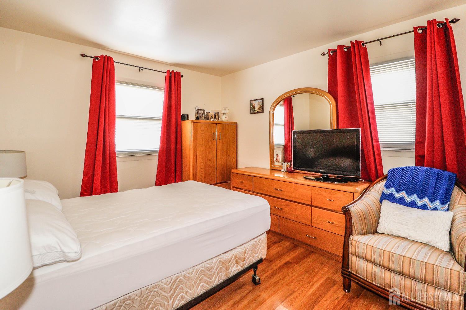 37 Patrick Street Carteret, NJ 07008 - Photo 20 of 30 a bedroom with a bed and a flat screen television