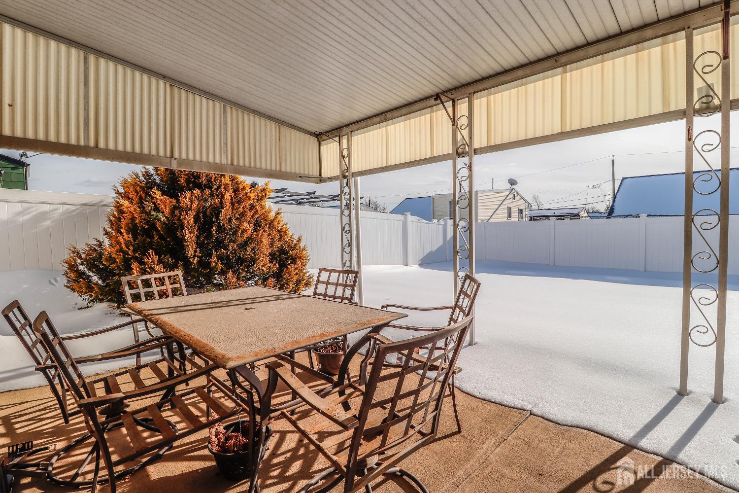 37 Patrick Street Carteret, NJ 07008 - Photo 27 of 30 a view of a patio with table and chairs and wooden fence
