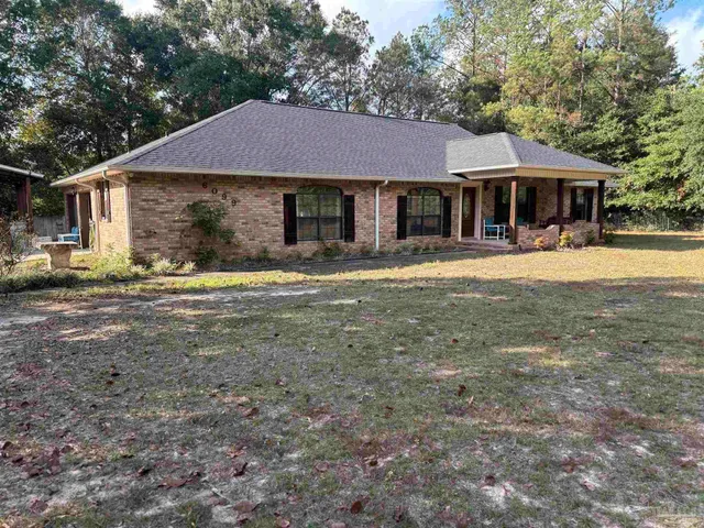 a front view of a house with a garden