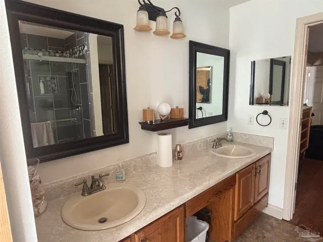 a bathroom with a double vanity sink and a mirror