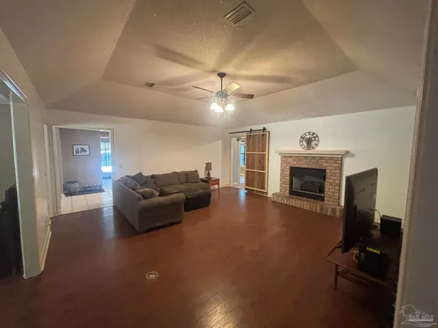 a living room with furniture a fireplace and a flat screen tv