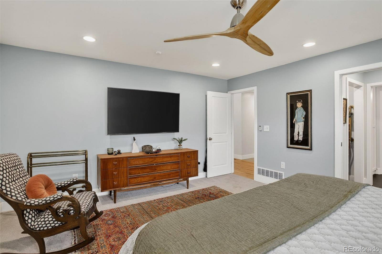 4595 West Lakeridge Road Denver, CO 80219 - Photo 13 of 50 a bedroom with furniture and a flat screen tv