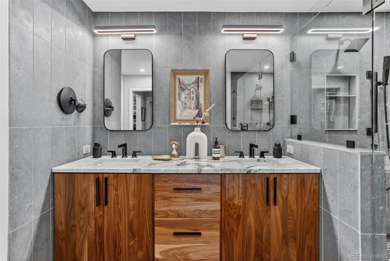 4595 West Lakeridge Road Denver, CO 80219 - Photo 15 of 50 a bathroom with double vanity sinks and a mirror
