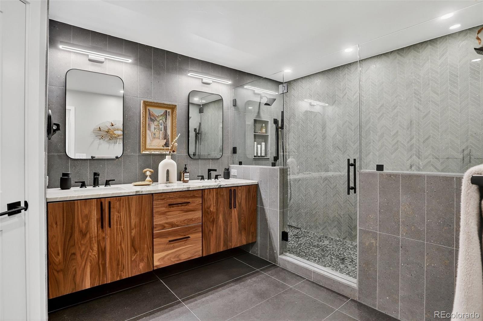 4595 West Lakeridge Road Denver, CO 80219 - Photo 16 of 50 a bathroom with a double vanity sink mirror and shower