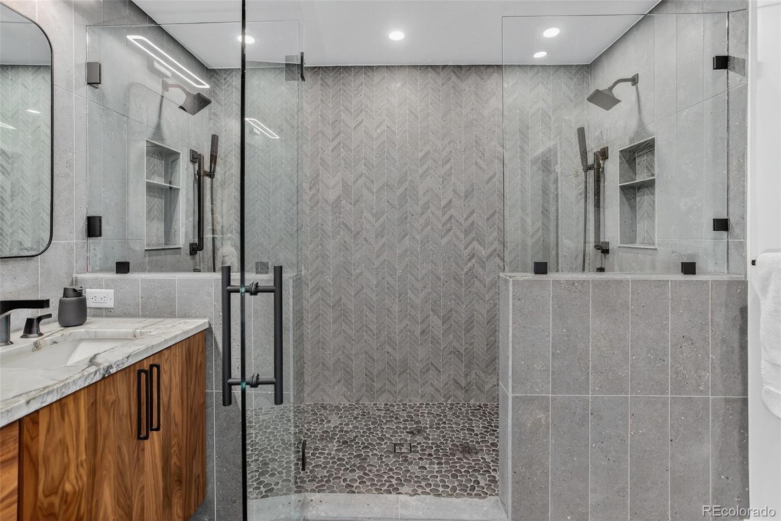 4595 West Lakeridge Road Denver, CO 80219 - Photo 17 of 50 a bathroom with a granite countertop sink a mirror and shower