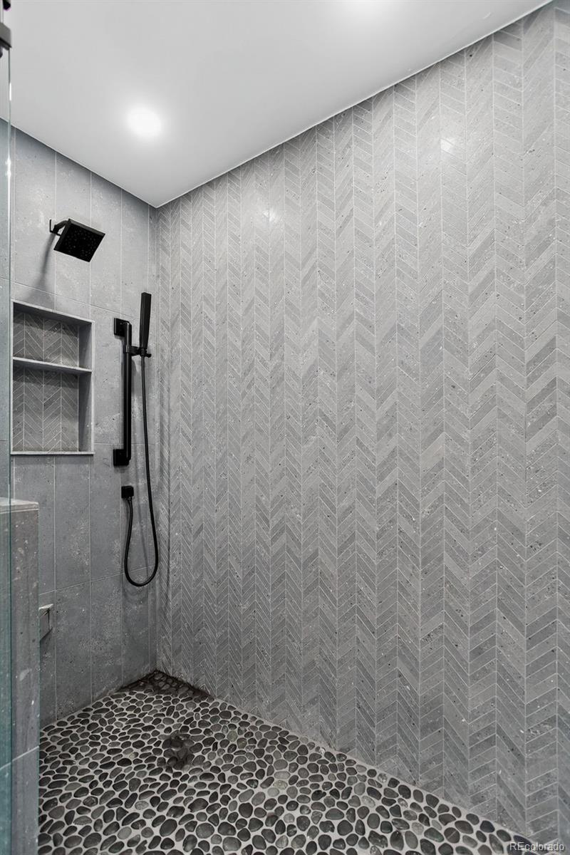 4595 West Lakeridge Road Denver, CO 80219 - Photo 18 of 50 a bathroom with a shower