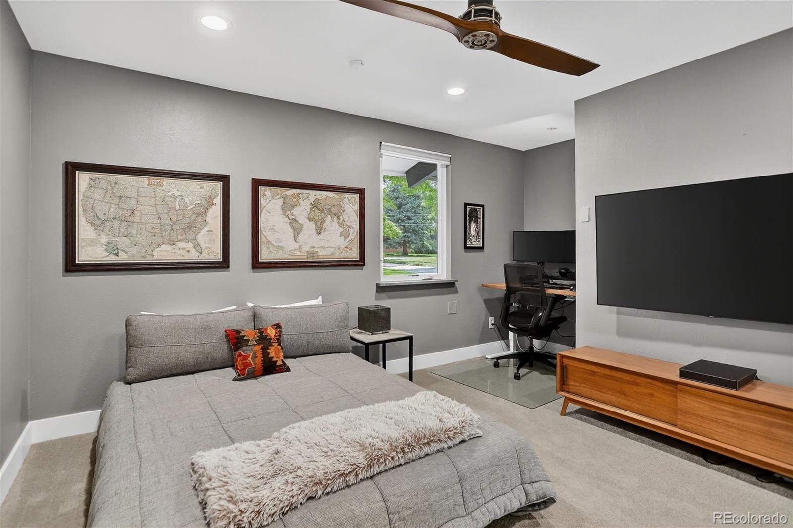 4595 West Lakeridge Road Denver, CO 80219 - Photo 20 of 50 a bedroom with furniture and a flat screen tv