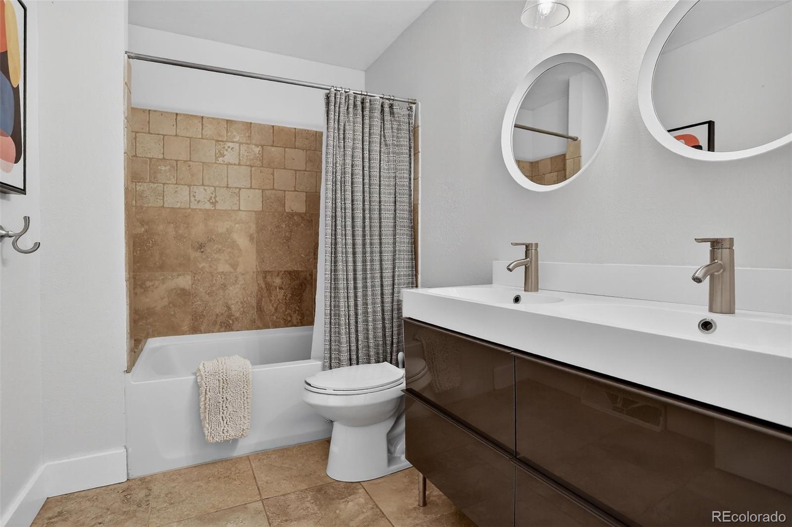 4595 West Lakeridge Road Denver, CO 80219 - Photo 21 of 50 a bathroom with a sink a toilet and shower