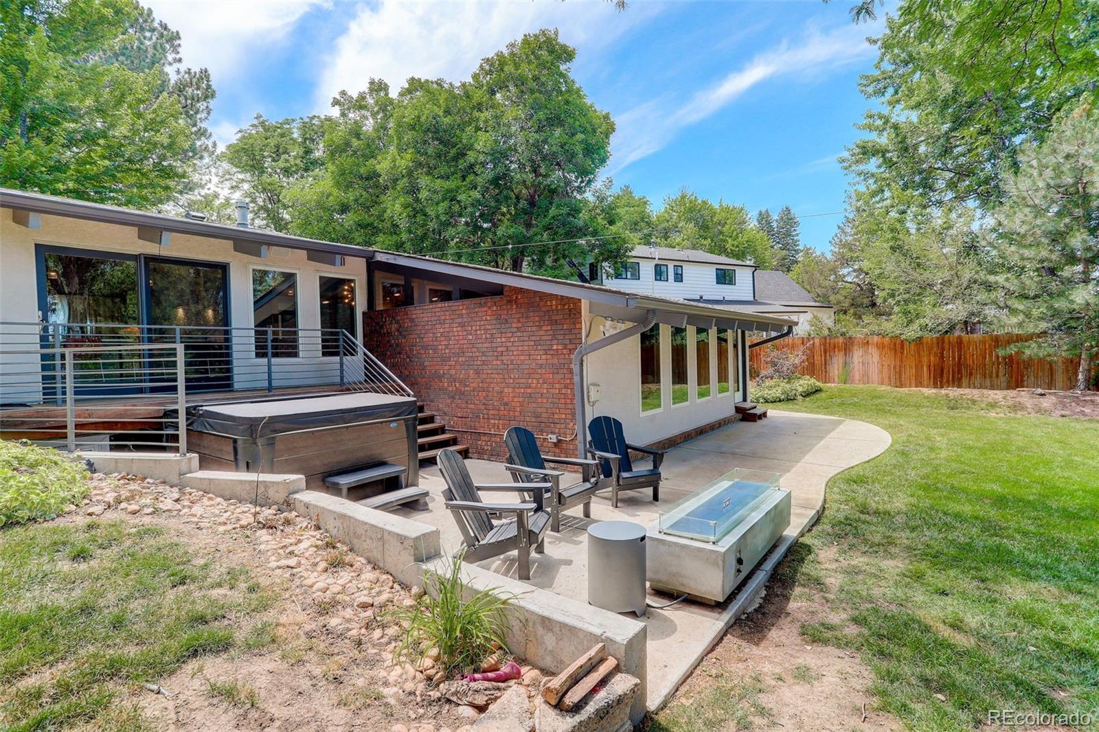 4595 West Lakeridge Road Denver, CO 80219 - Photo 27 of 50 a view of a patio with table and chairs with wooden floor and fence