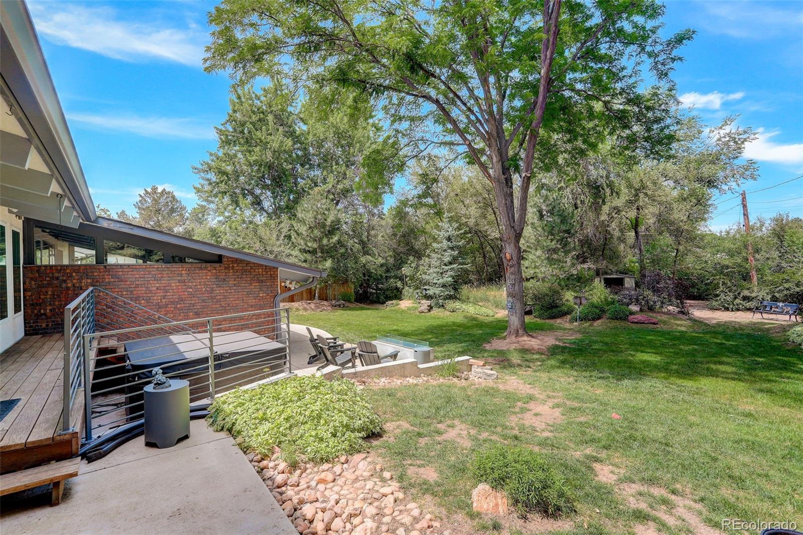 4595 West Lakeridge Road Denver, CO 80219 - Photo 28 of 50 a backyard of a house with barbeque oven table and chairs