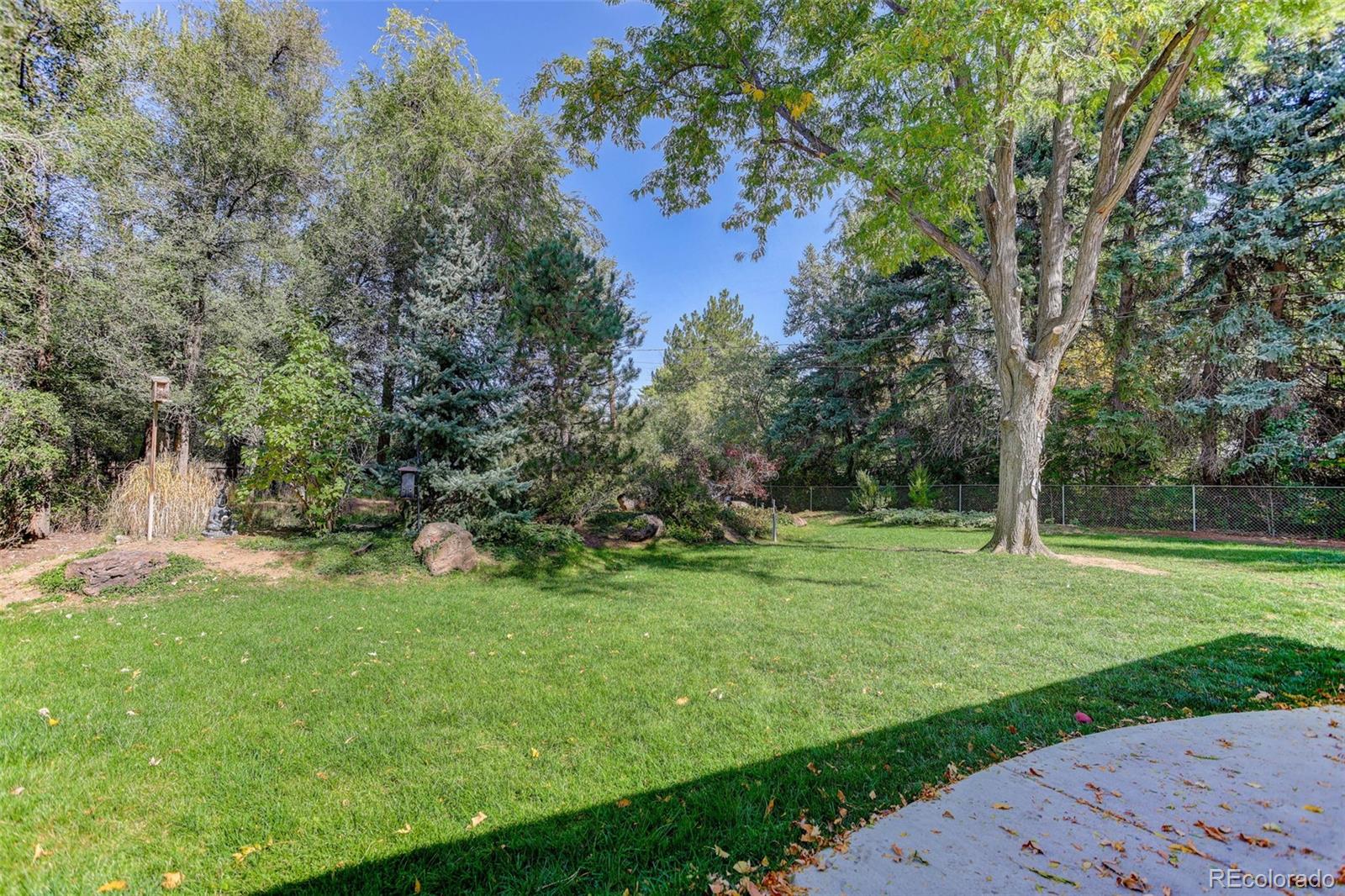4595 West Lakeridge Road Denver, CO 80219 - Photo 31 of 50 a view of a park with large trees