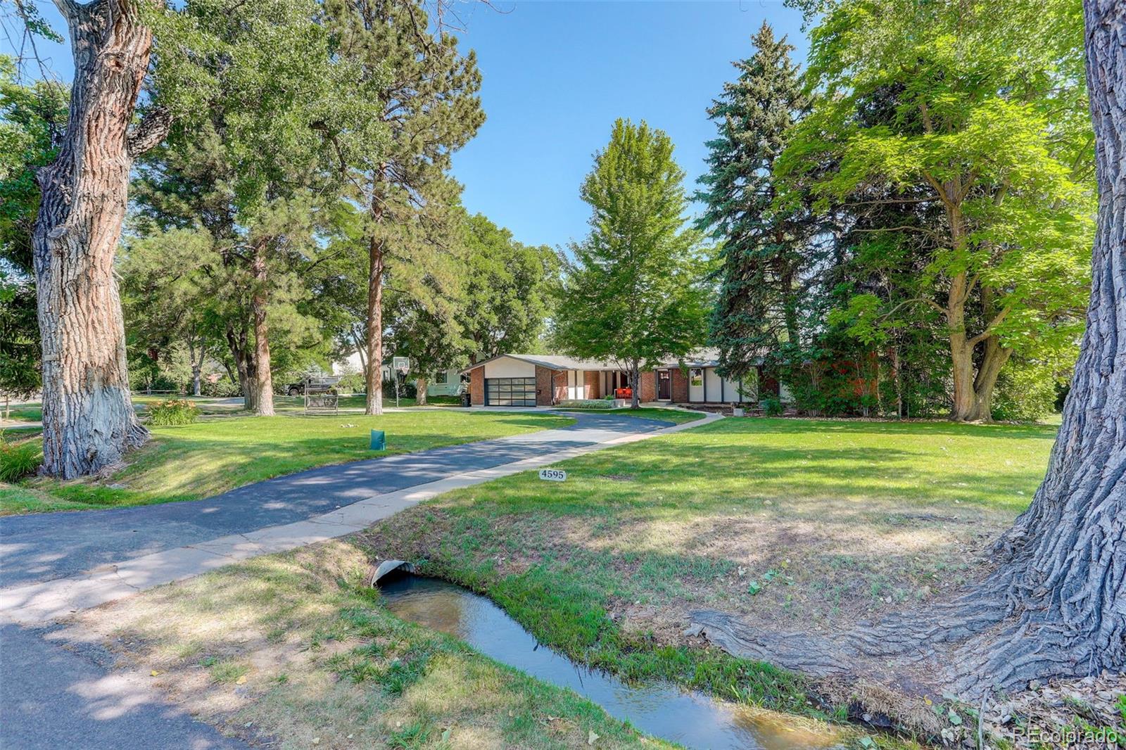 4595 West Lakeridge Road Denver, CO 80219 - Photo 33 of 50 a view of a house with a big yard