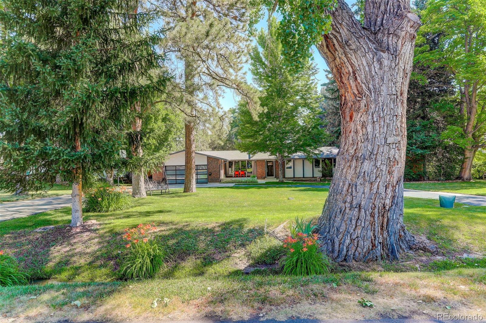 4595 West Lakeridge Road Denver, CO 80219 - Photo 36 of 50 a front view of a house with garden