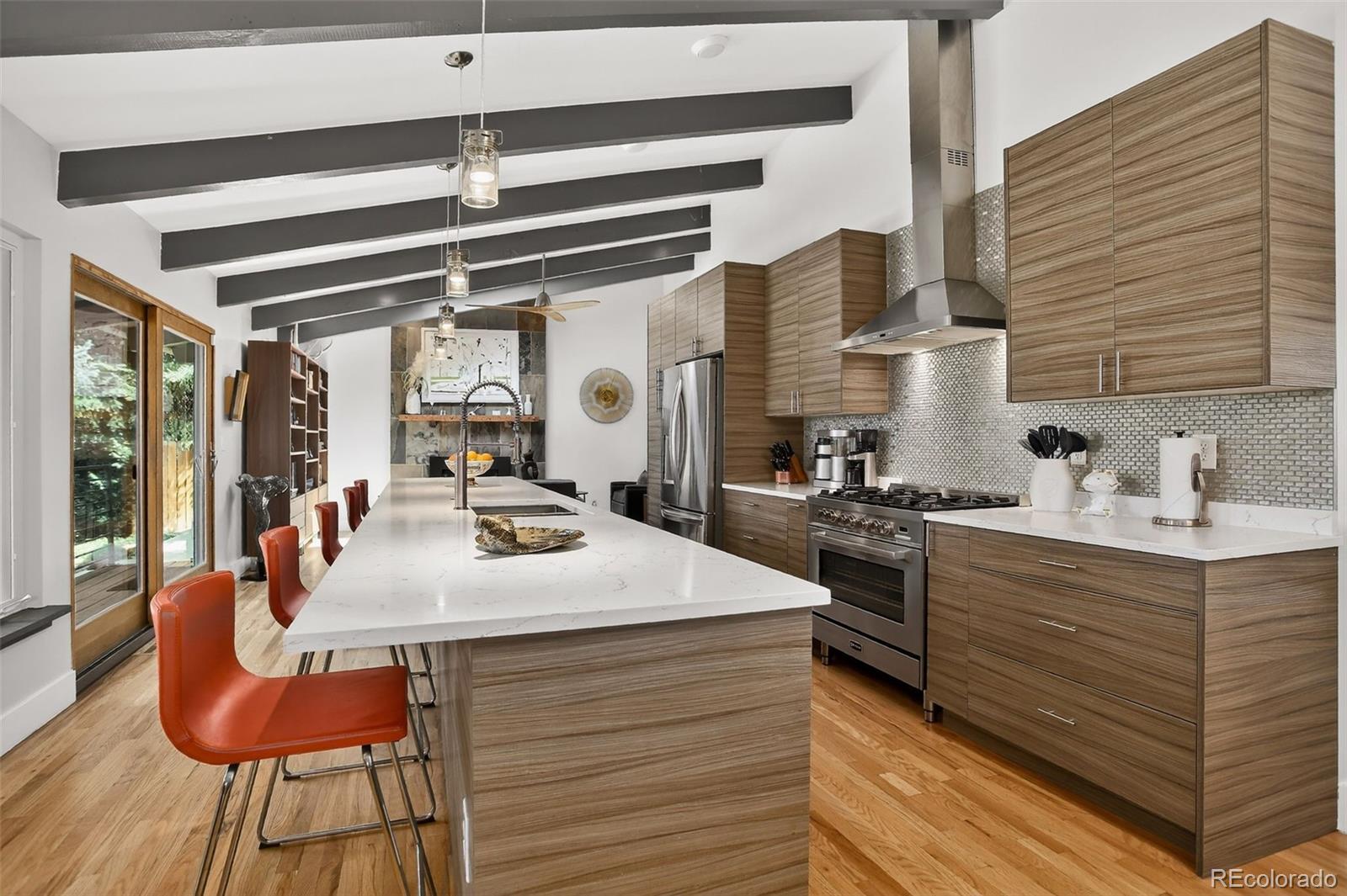 4595 West Lakeridge Road Denver, CO 80219 - Photo 4 of 50 a dining hall with stainless steel appliances kitchen island granite countertop a table chairs and a sink