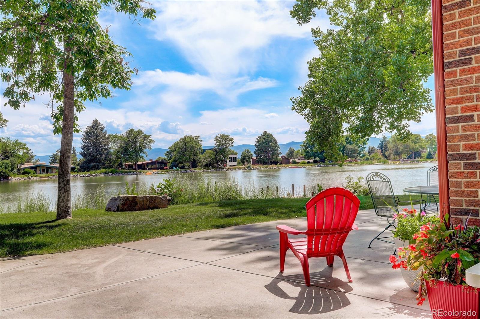4595 West Lakeridge Road Denver, CO 80219 - Photo 41 of 50 a view of a lake with a table and a chairs