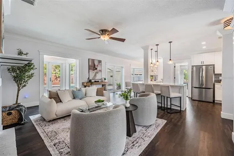 a living room with furniture and a chandelier