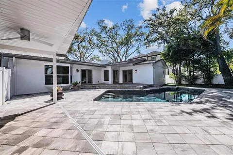 a view of a backyard with table and chairs and potted plants