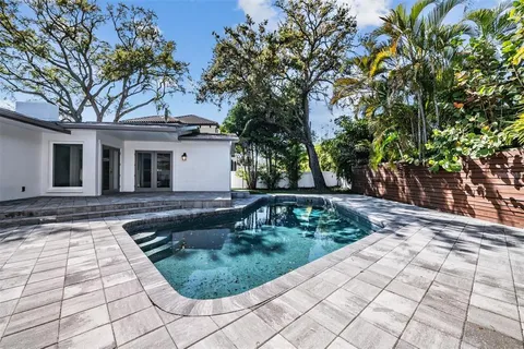 a view of a backyard with large trees