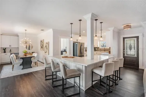 a dining room with furniture and wooden floor
