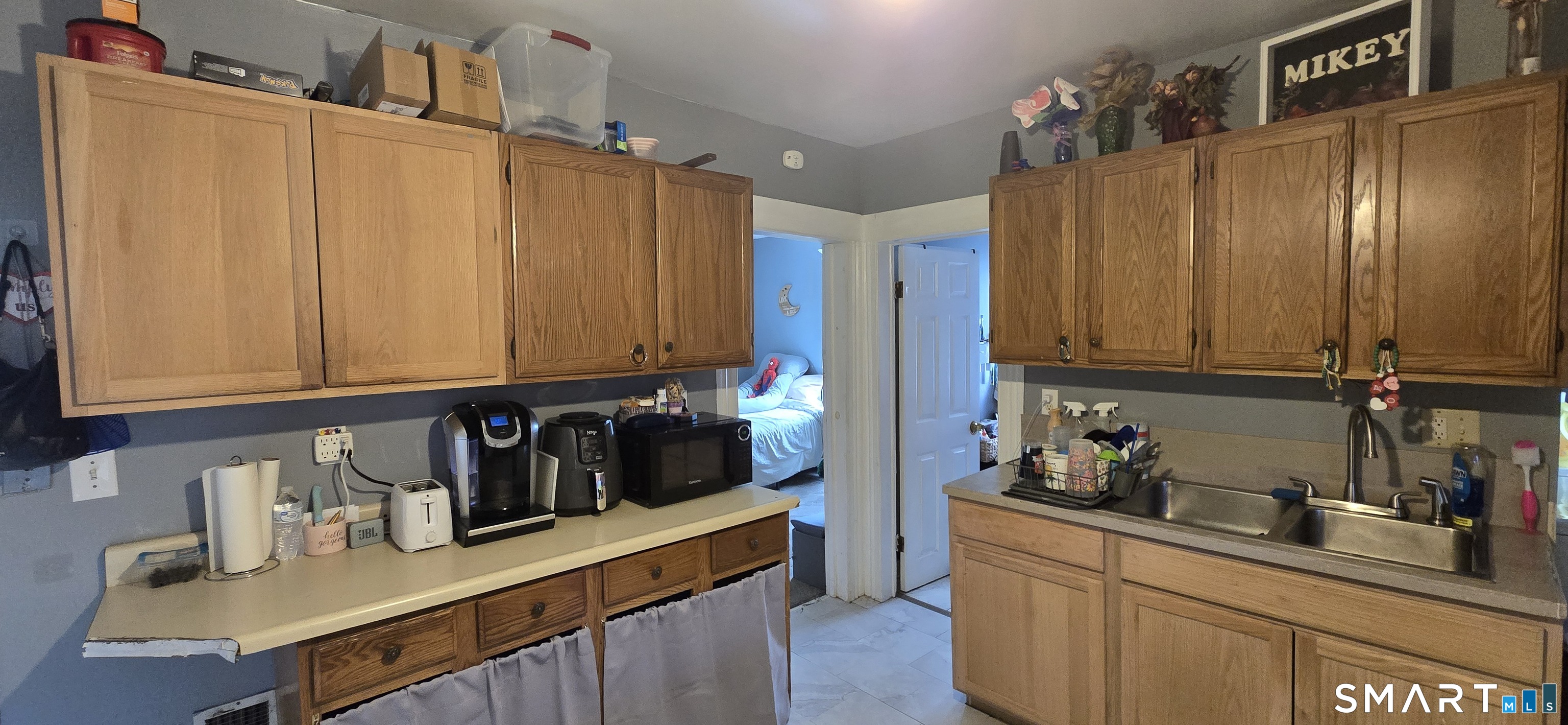 25 High Street Torrington, CT 06790 - Photo 3 of 16 a kitchen with stainless steel appliances wooden cabinets a sink and a refrigerator