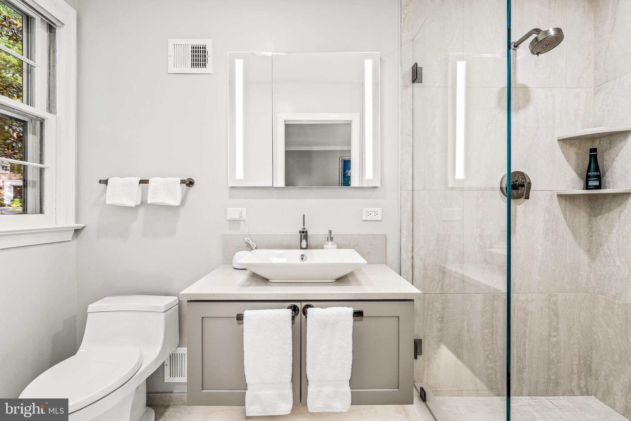 4225 50th Street Northwest Washington, DC 20016 - Photo 15 of 30 a bathroom with a sink vanity toilet and shower