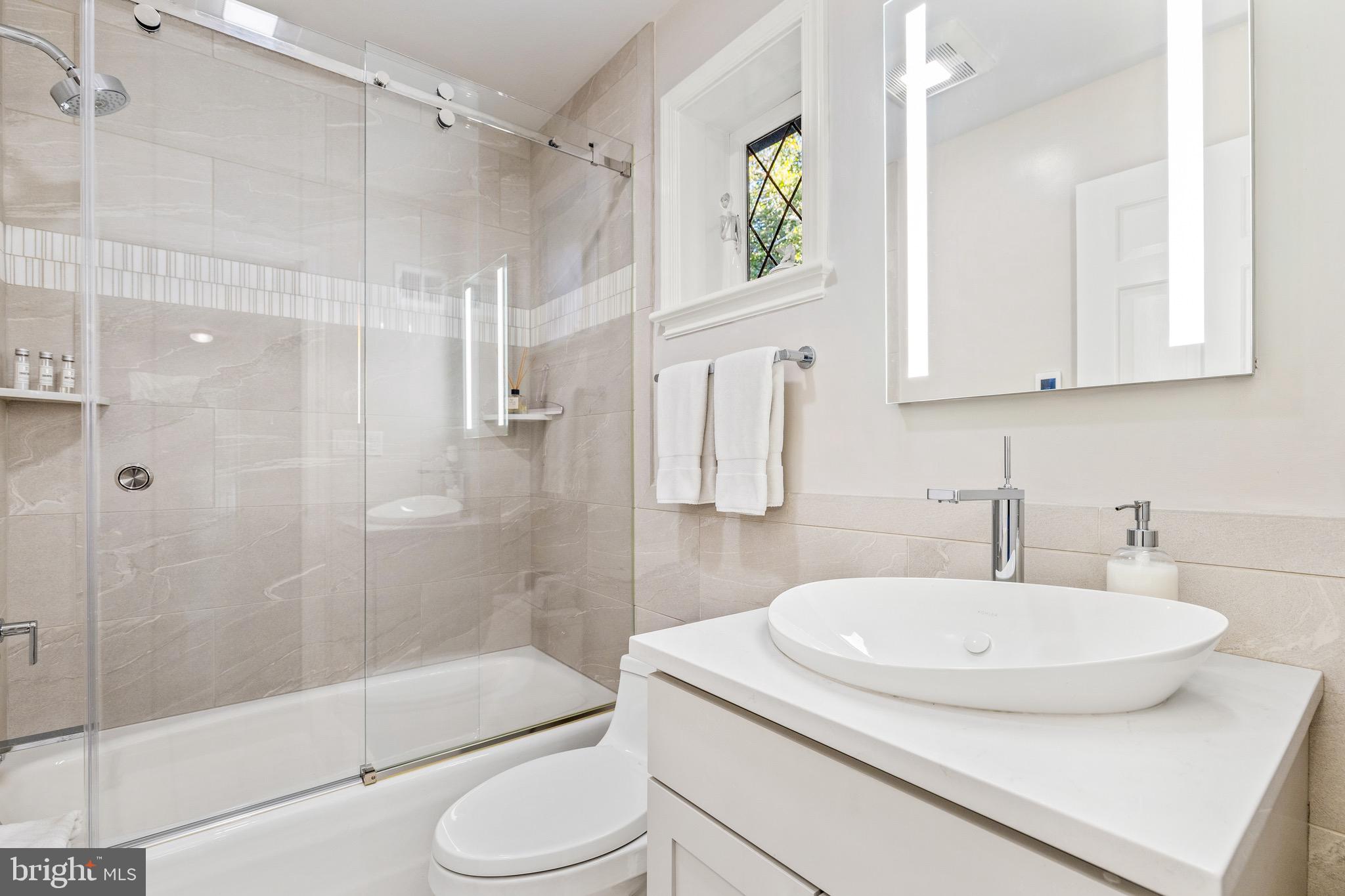 4225 50th Street Northwest Washington, DC 20016 - Photo 18 of 30 a bathroom with a sink toilet and shower