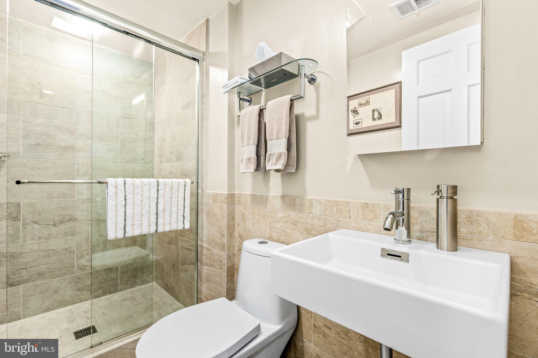 4225 50th Street Northwest Washington, DC 20016 - Photo 22 of 30 a bathroom with a sink toilet and shower