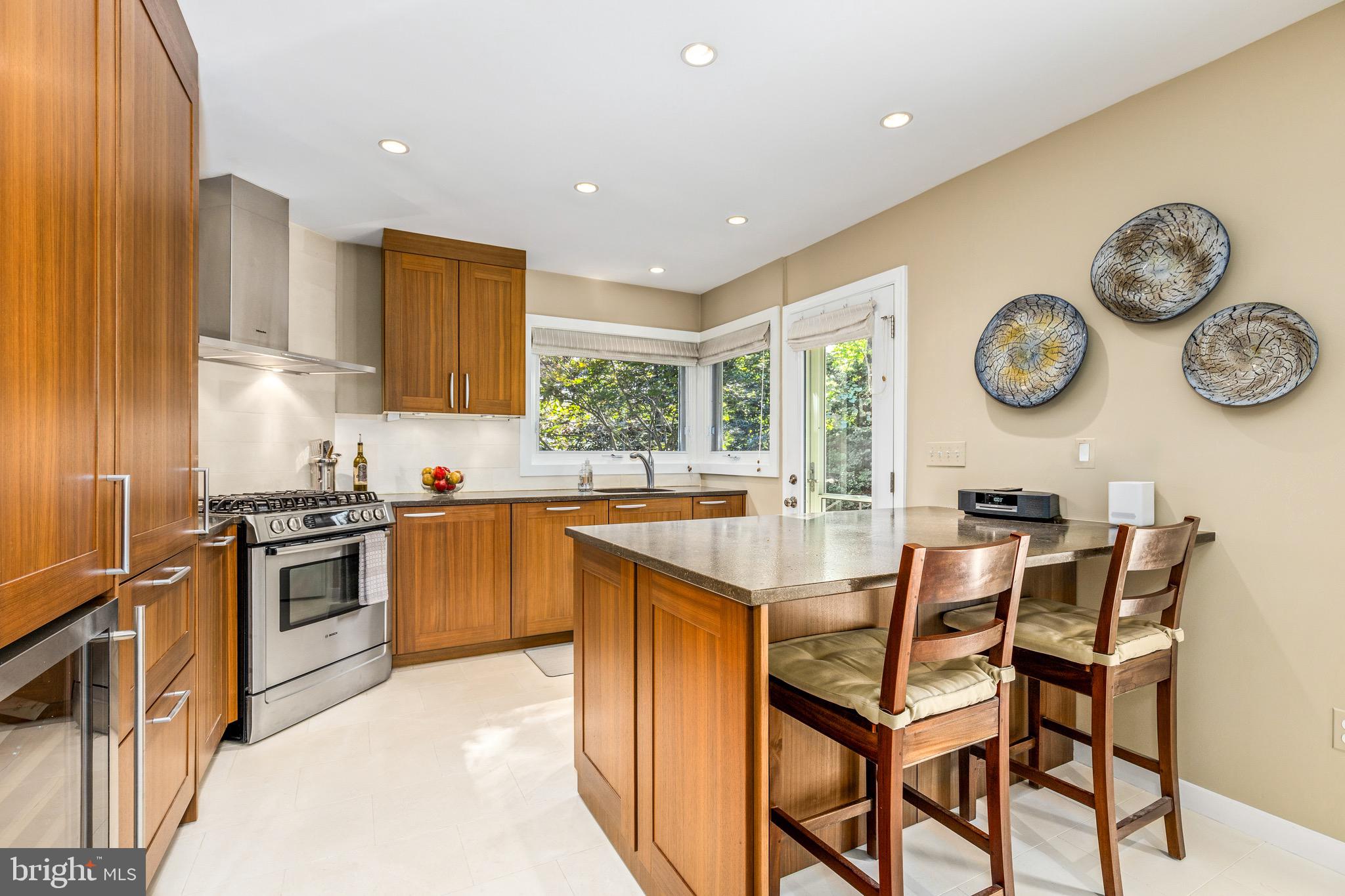 4225 50th Street Northwest Washington, DC 20016 - Photo 8 of 30 a kitchen with a table chairs and a stove top oven with wooden floor