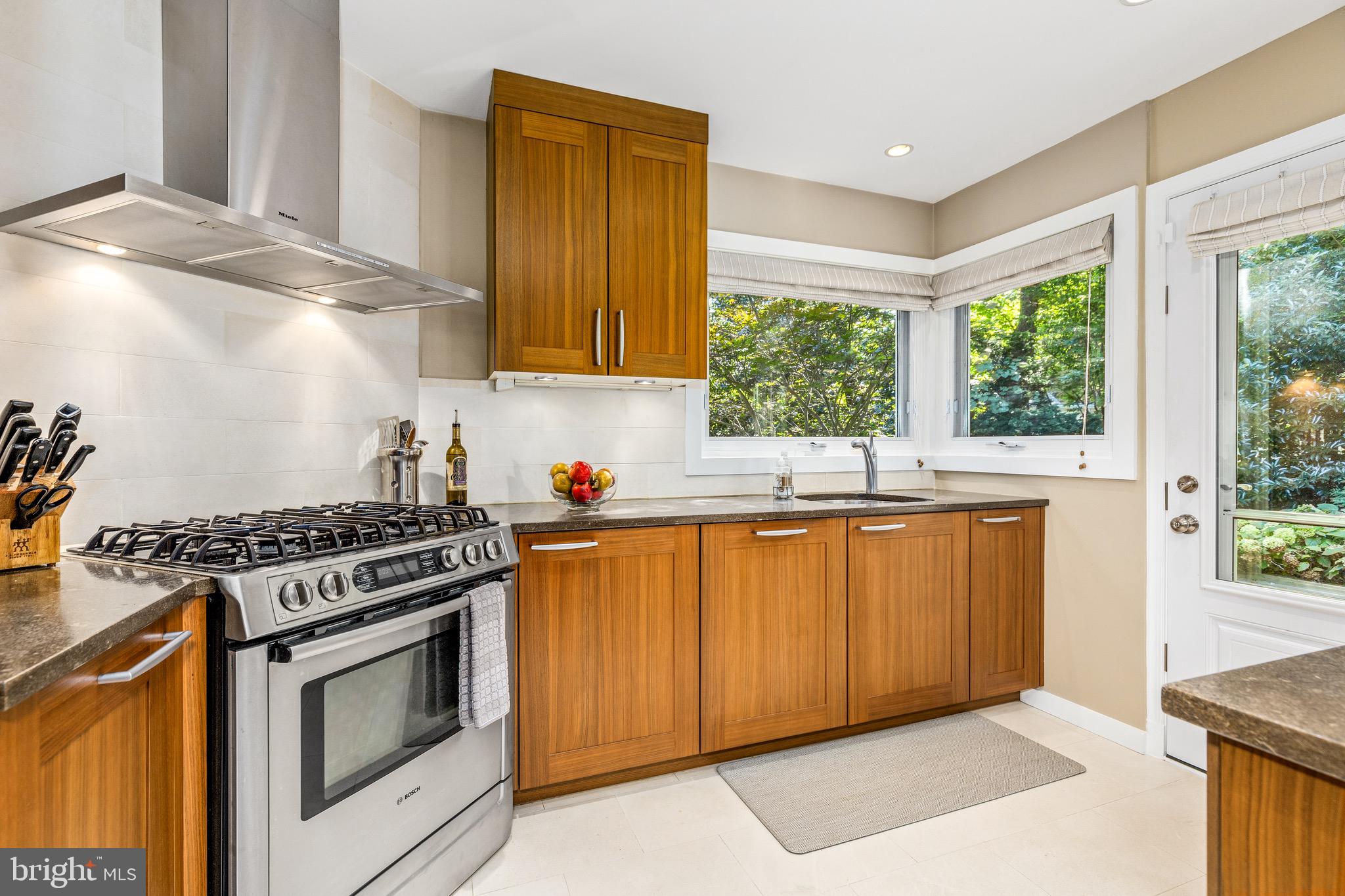 4225 50th Street Northwest Washington, DC 20016 - Photo 9 of 30 a kitchen with granite countertop a stove and a sink