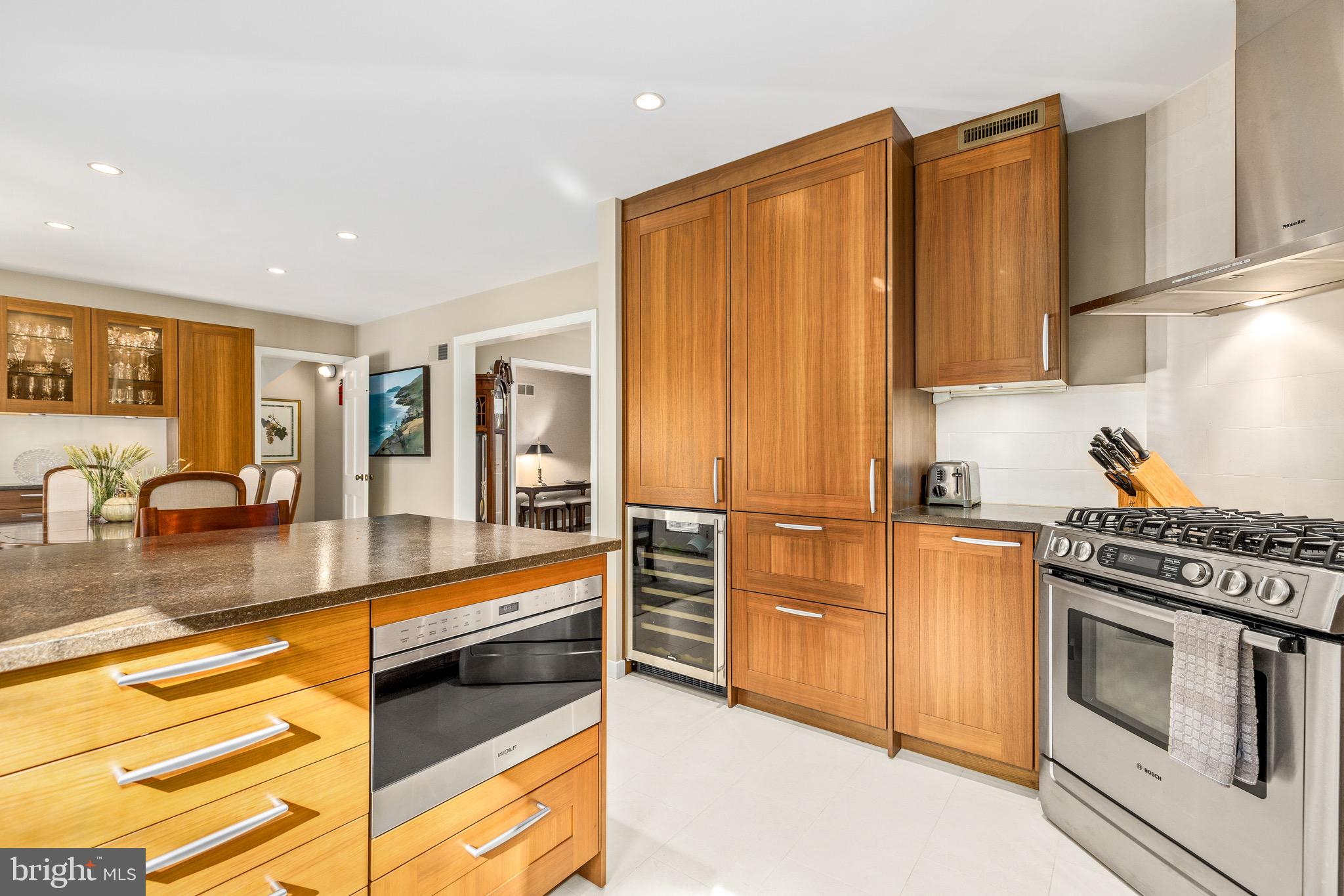 4225 50th Street Northwest Washington, DC 20016 - Photo 10 of 30 a kitchen with stainless steel appliances granite countertop a stove a sink and a microwave