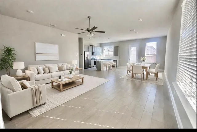 a living room with furniture and a large window