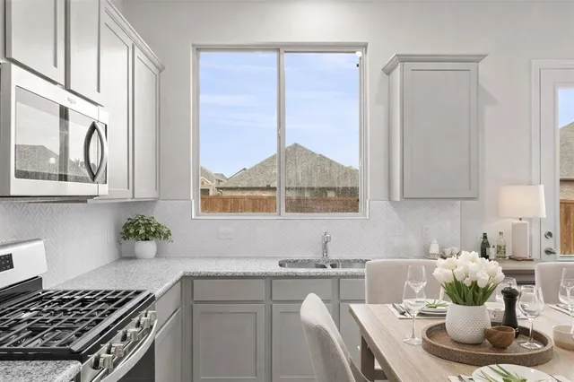 a kitchen with a stove a sink and a cabinets