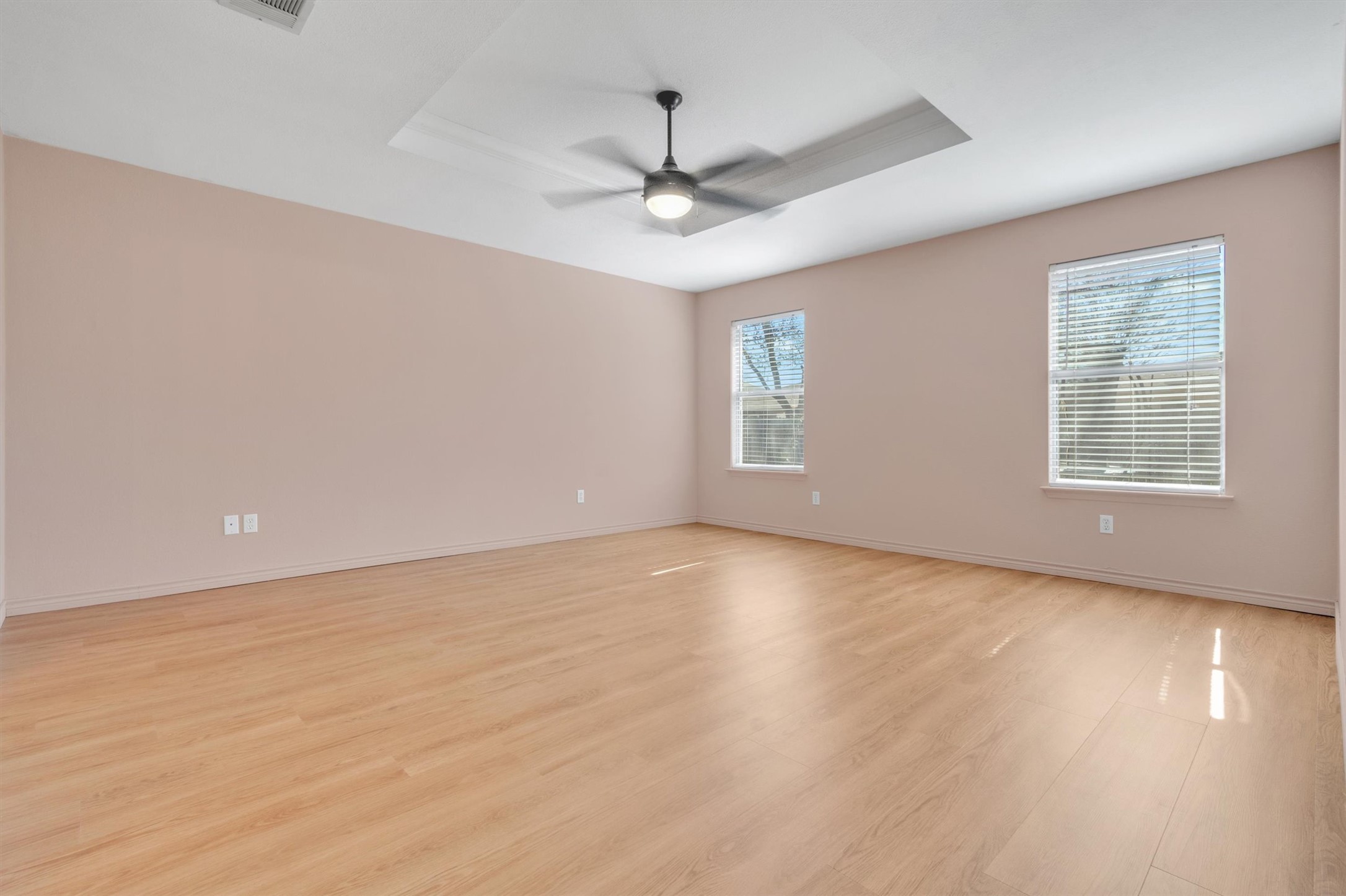100 Madisons Way Buda, TX 78610 - Photo 16 of 30 Spare room with a tray ceiling, light wood-style floors, and a ceiling fan