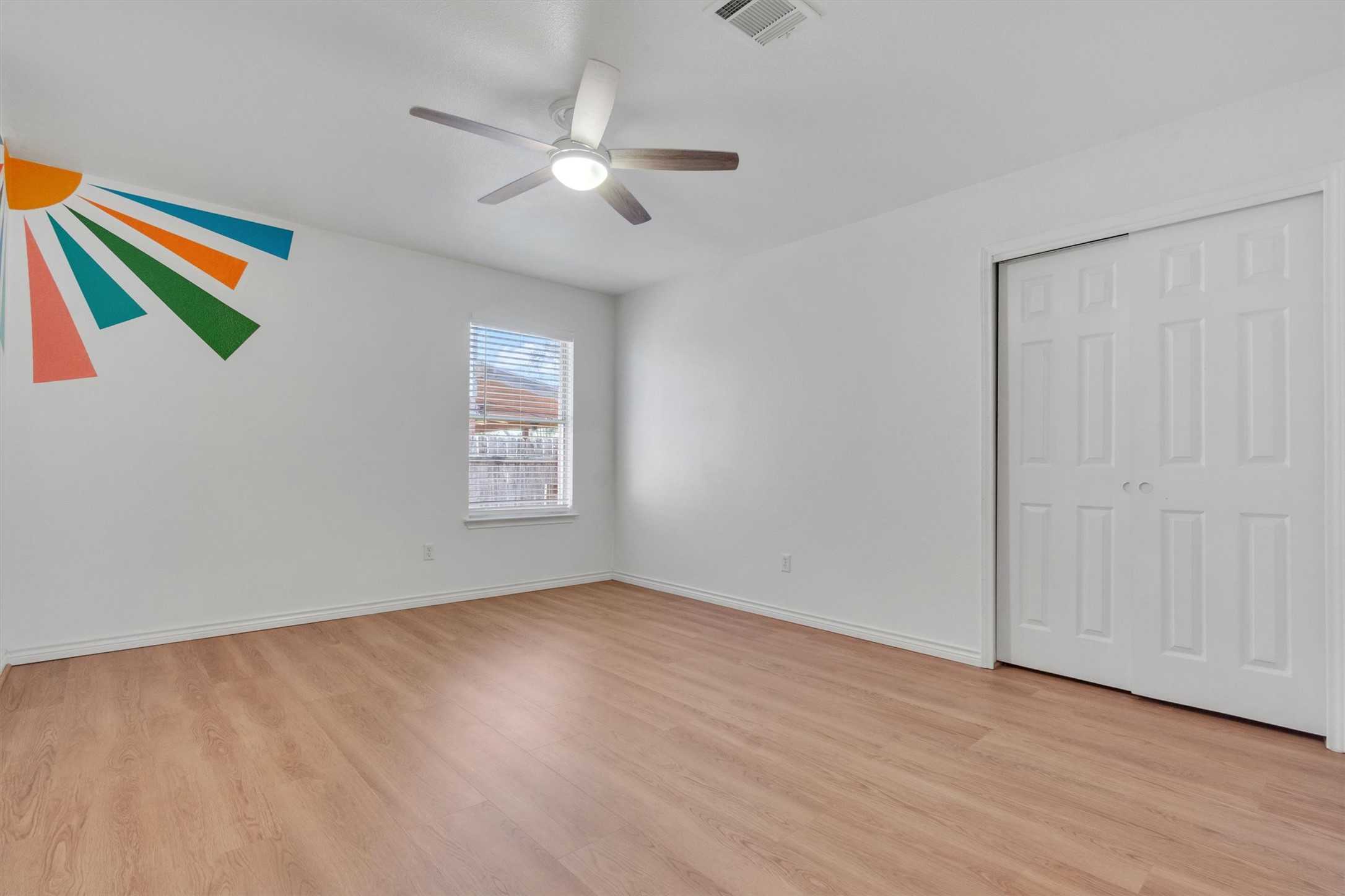100 Madisons Way Buda, TX 78610 - Photo 22 of 30 Unfurnished bedroom featuring light wood finished floors, a closet, and a ceiling fan
