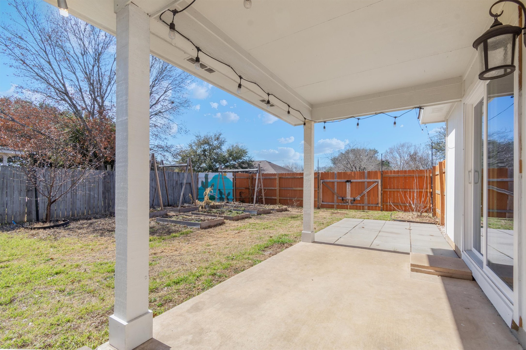 100 Madisons Way Buda, TX 78610 - Photo 26 of 30 Fenced backyard featuring a patio area and a vegetable garden