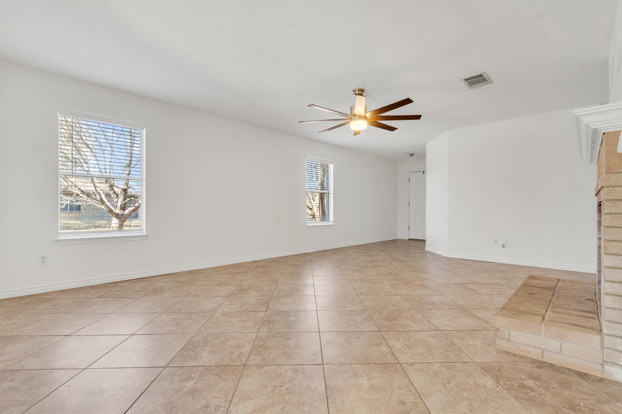 100 Madisons Way Buda, TX 78610 - Photo 6 of 30 Empty room featuring a ceiling fan and light tile patterned floors