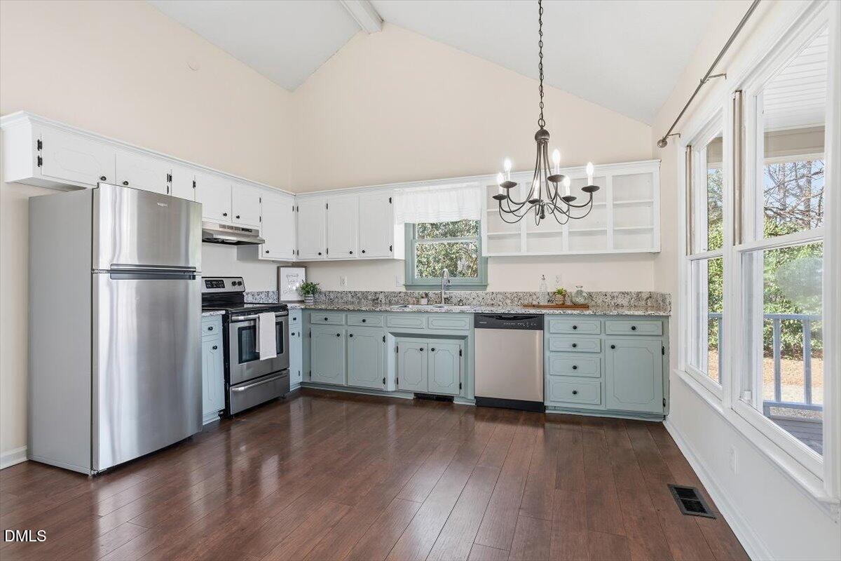 1334 Langdon Road Angier, NC 27501 - Photo 21 of 36 a kitchen with a refrigerator stove and wooden floor