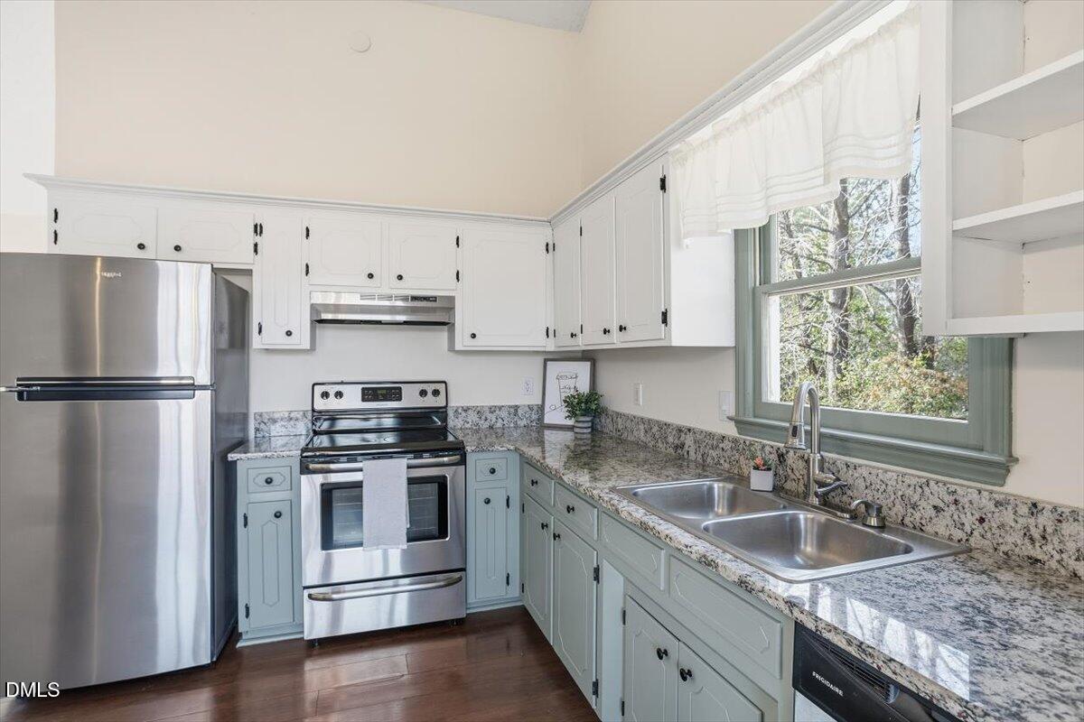 1334 Langdon Road Angier, NC 27501 - Photo 23 of 36 a kitchen with stainless steel appliances granite countertop a sink stove and refrigerator