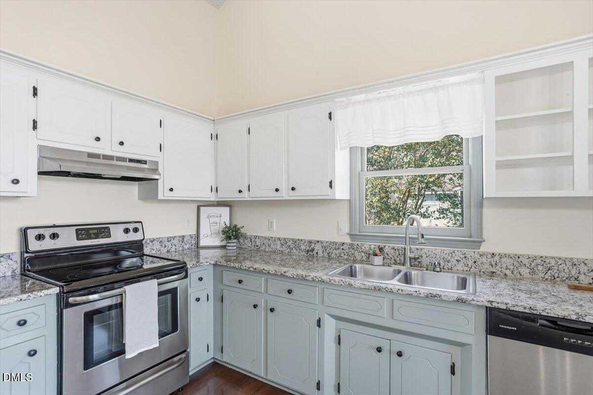 1334 Langdon Road Angier, NC 27501 - Photo 24 of 36 a kitchen with stainless steel appliances granite countertop a sink stove and cabinets