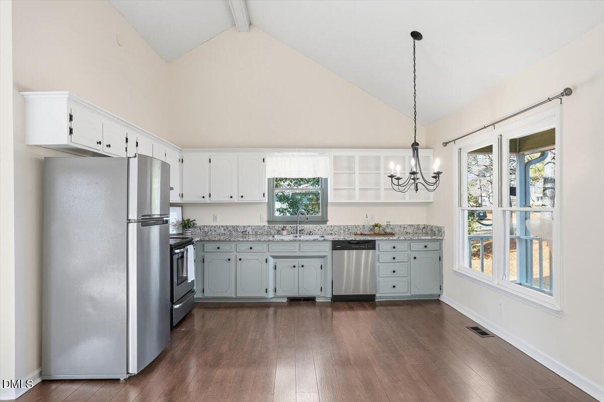 1334 Langdon Road Angier, NC 27501 - Photo 25 of 36 a kitchen with stainless steel appliances granite countertop a refrigerator a sink and white cabinets