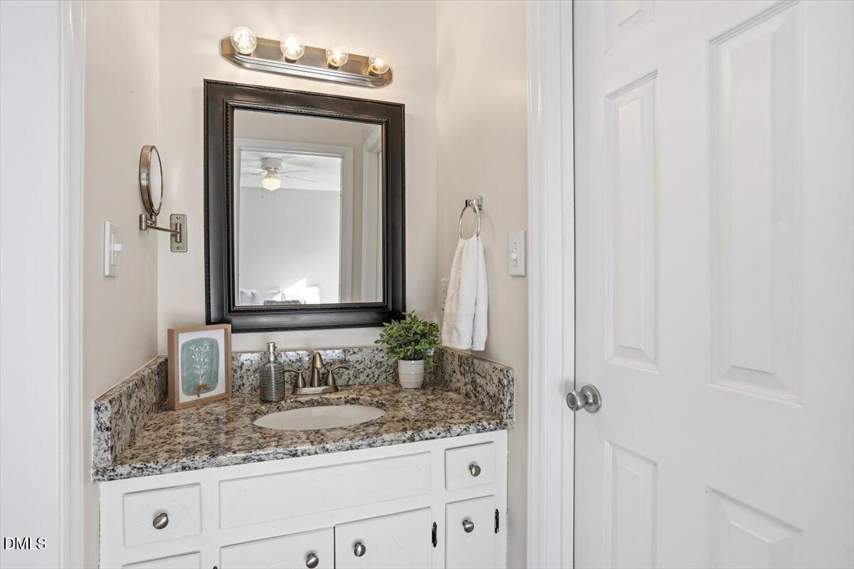 1334 Langdon Road Angier, NC 27501 - Photo 31 of 36 a bathroom with a granite countertop sink and a mirror