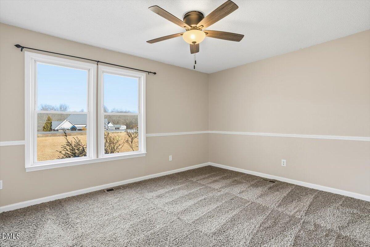 1334 Langdon Road Angier, NC 27501 - Photo 33 of 36 an empty room with a window and a fan