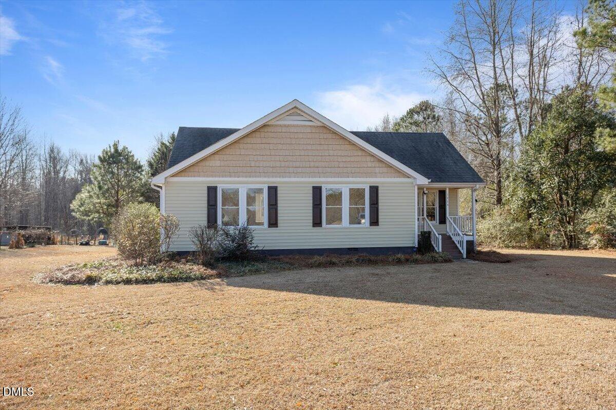 1334 Langdon Road Angier, NC 27501 - Photo 4 of 36 a front view of a house with a dirt yard and a large tree