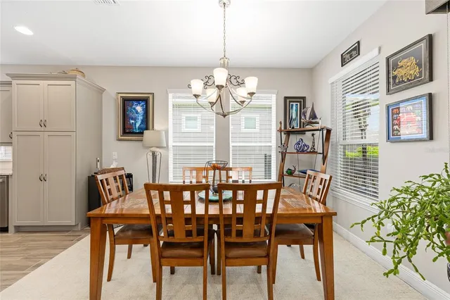 a view of a dining room with furniture and a chandelier