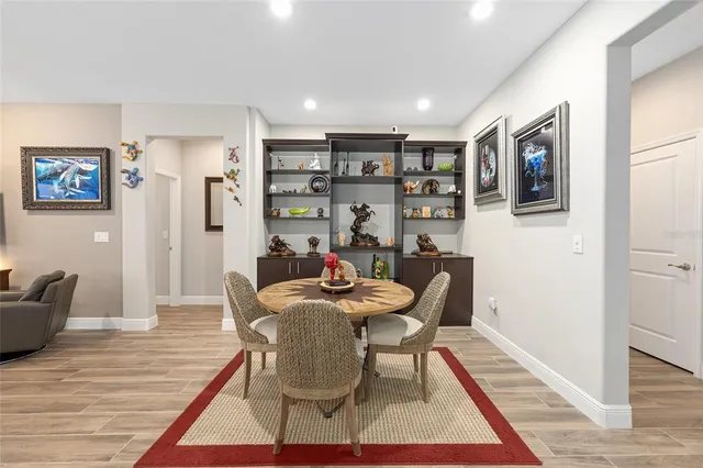 a dining room with furniture and wooden floor