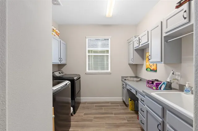 a kitchen with a sink appliances and cabinets